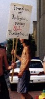 Protestor in front of police car