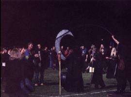 Gathering around the cauldron pinata at Coven Oldenwilde's Samhain 97 free public Witch ritual at Asheville's Memorial Stadium