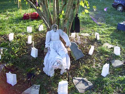 "Death" with tombstones & luminaries